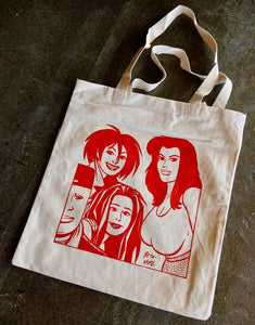 A photo of a canvas tote bag featuring characters from Love and Rockets in red ink.